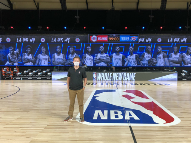 Andy stands at center court